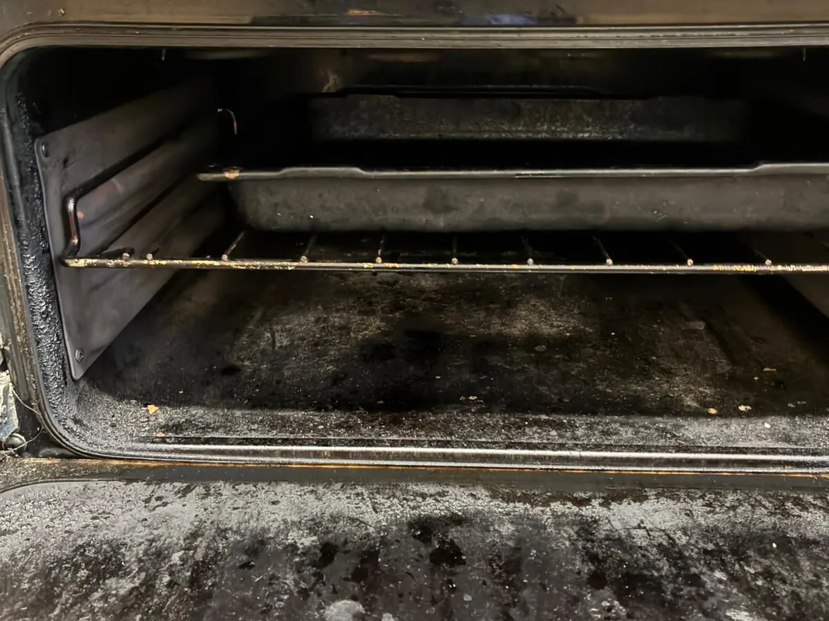 Greasy oven grill before cleaning
